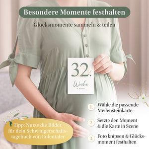 Schwangere Frau hält Meilensteinkarte '32. Woche' – Besondere Momente festhalten mit Eulentaler Schwangerschaftstagebuch.